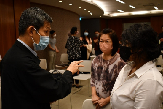 Chief Prosecutor Tan Kiat Pheng (left) interacting with law students, Siew Gek Wah (middle) and Maria Santosh (right).