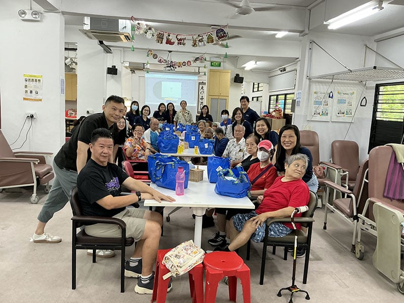 SUSS School of Business Staff distributing care packs to the METTA residence
