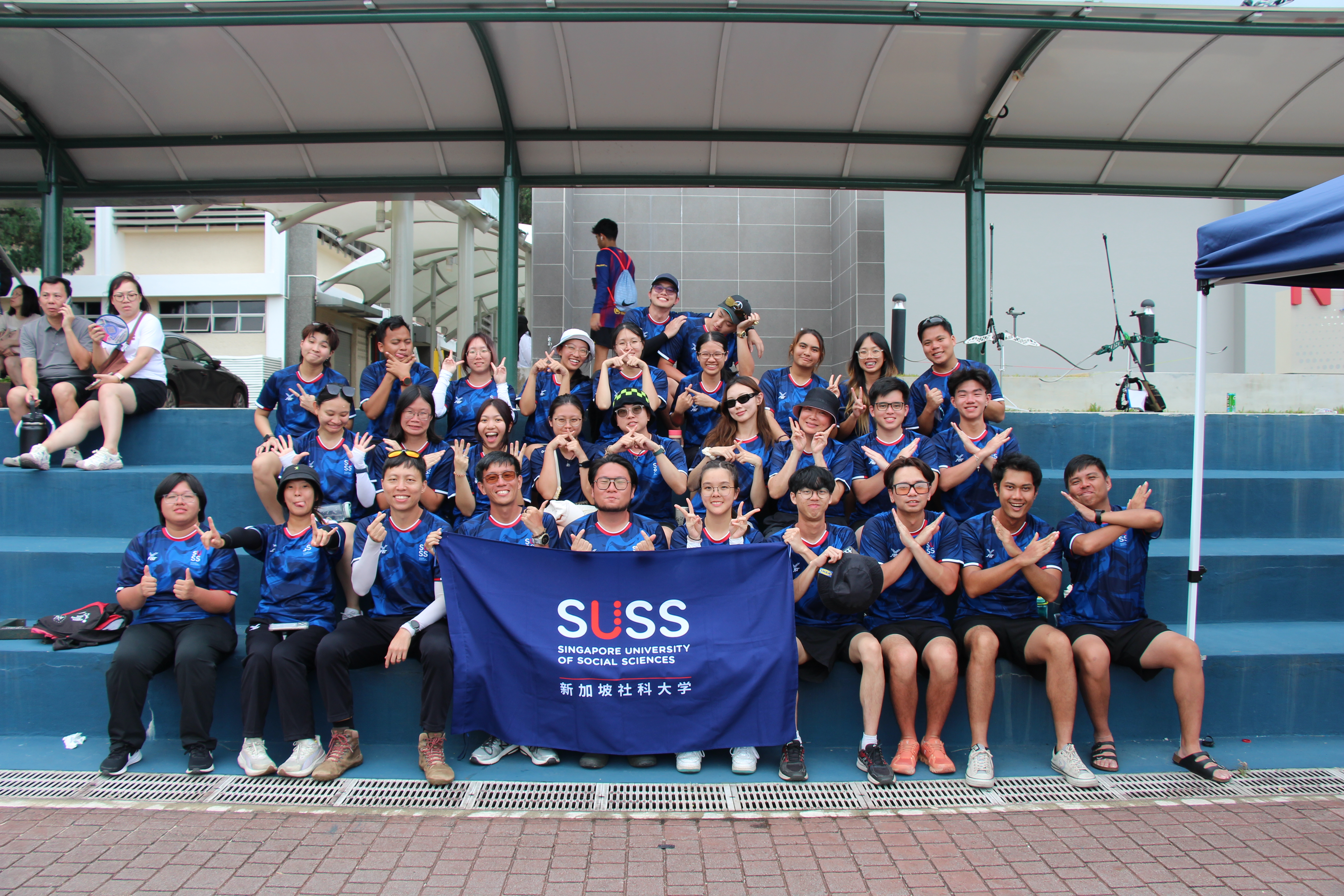 SUSS Archery Competition Group coming together as a team on Day 2 of the competition..JPG