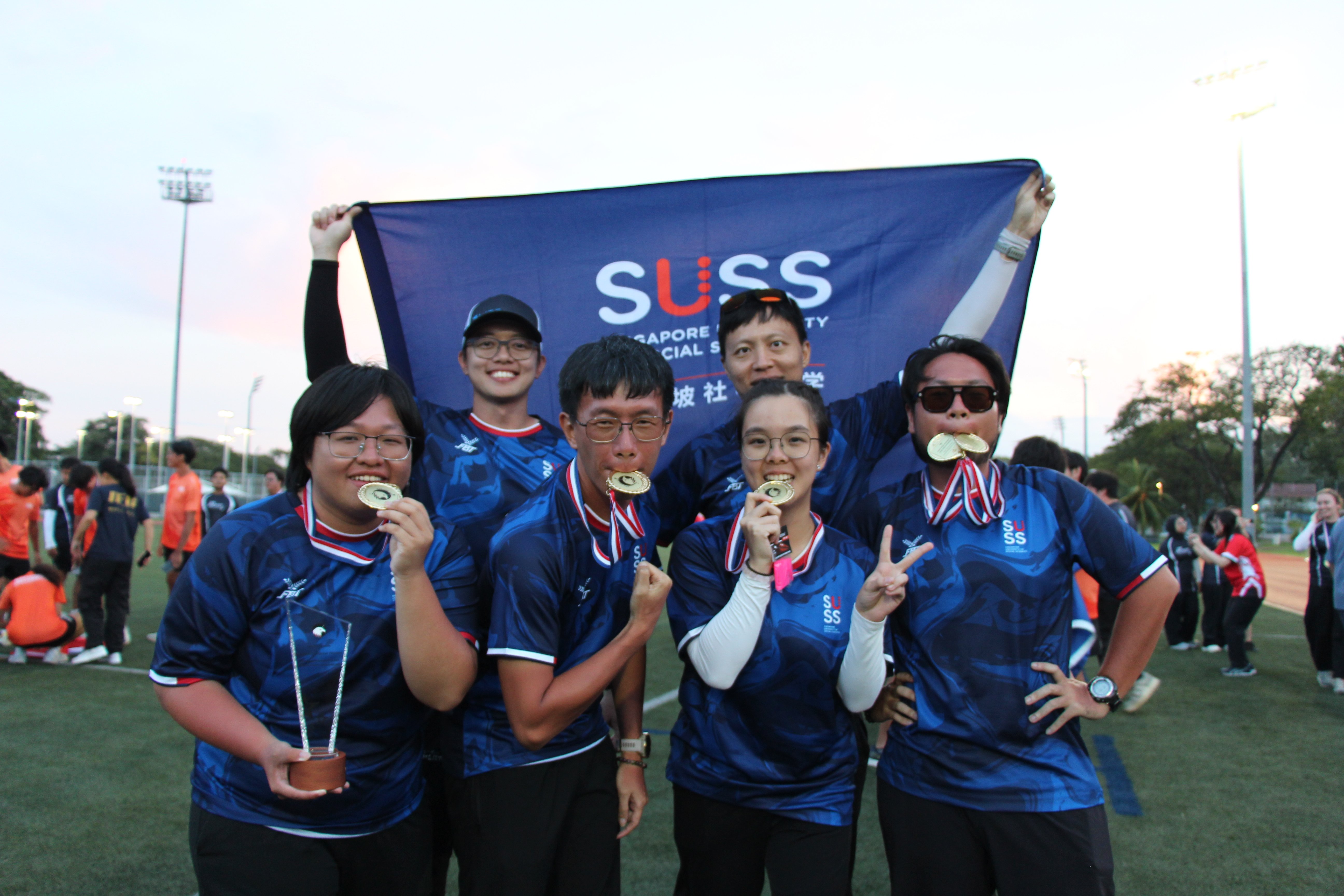 Student athletes celebrating their achievements together after the competition.