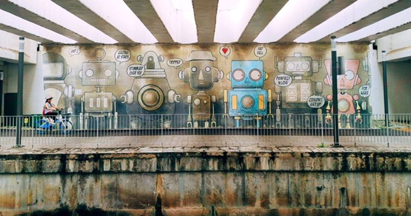 A participant immediately showcases her skills as she snaps a shot of the robot mural.