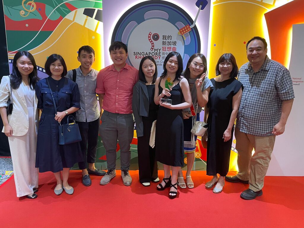 Digital Media students with their professors celebrating the team’s success