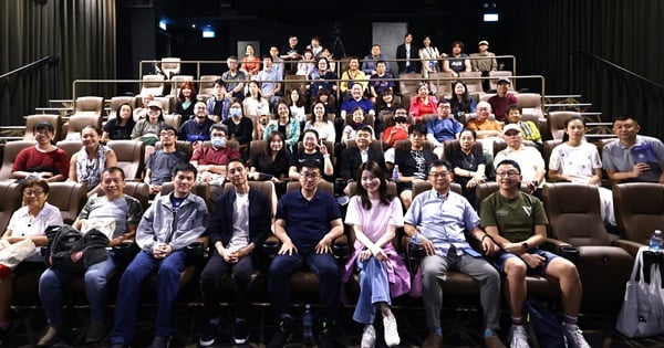 Group photo of panel discussion speakers with audience