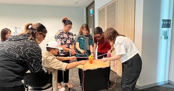 Members completing a series of activities in a simulation as part of the induction.