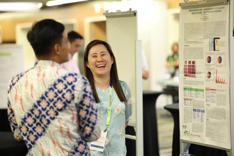 Delegates viewing abstract submissions on display during the conference Delegates viewing abstract submissions on display during the conference