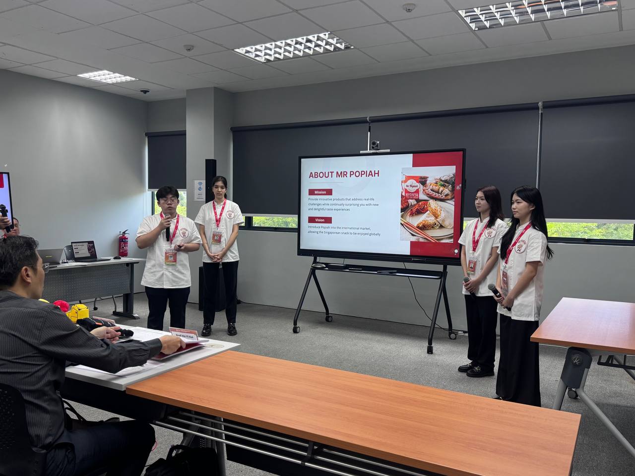 Fishboat Time presenting their winning proposal to the judges (from left to right: Shawn Lai Guang Shen, Sita Hamilton, Gallardo Roginelle Amaro, and Amanda Koh Zixuan).