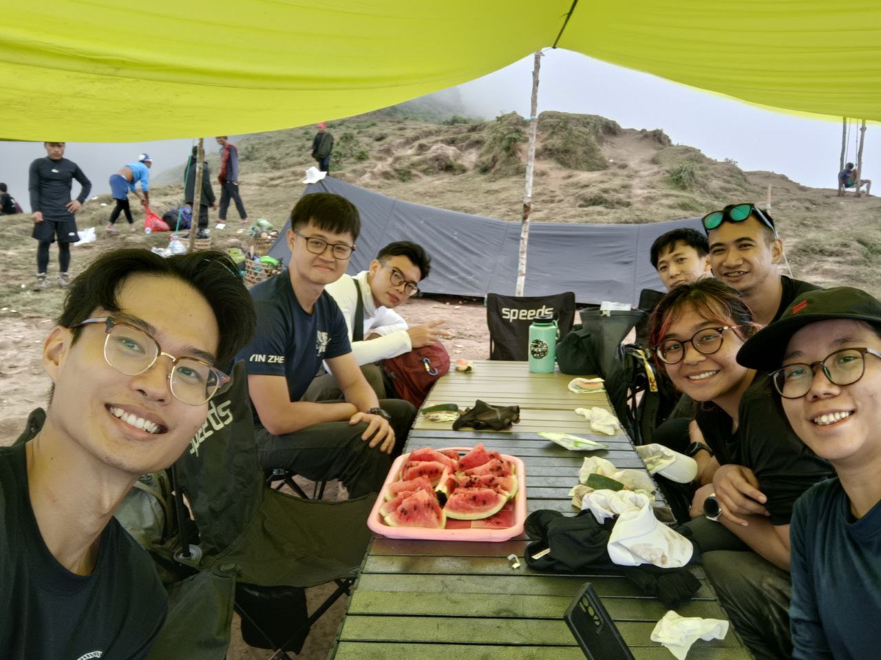 A few members at the Pergasingan Hill base camp, enjoying refreshing watermelon prepared by the porters.