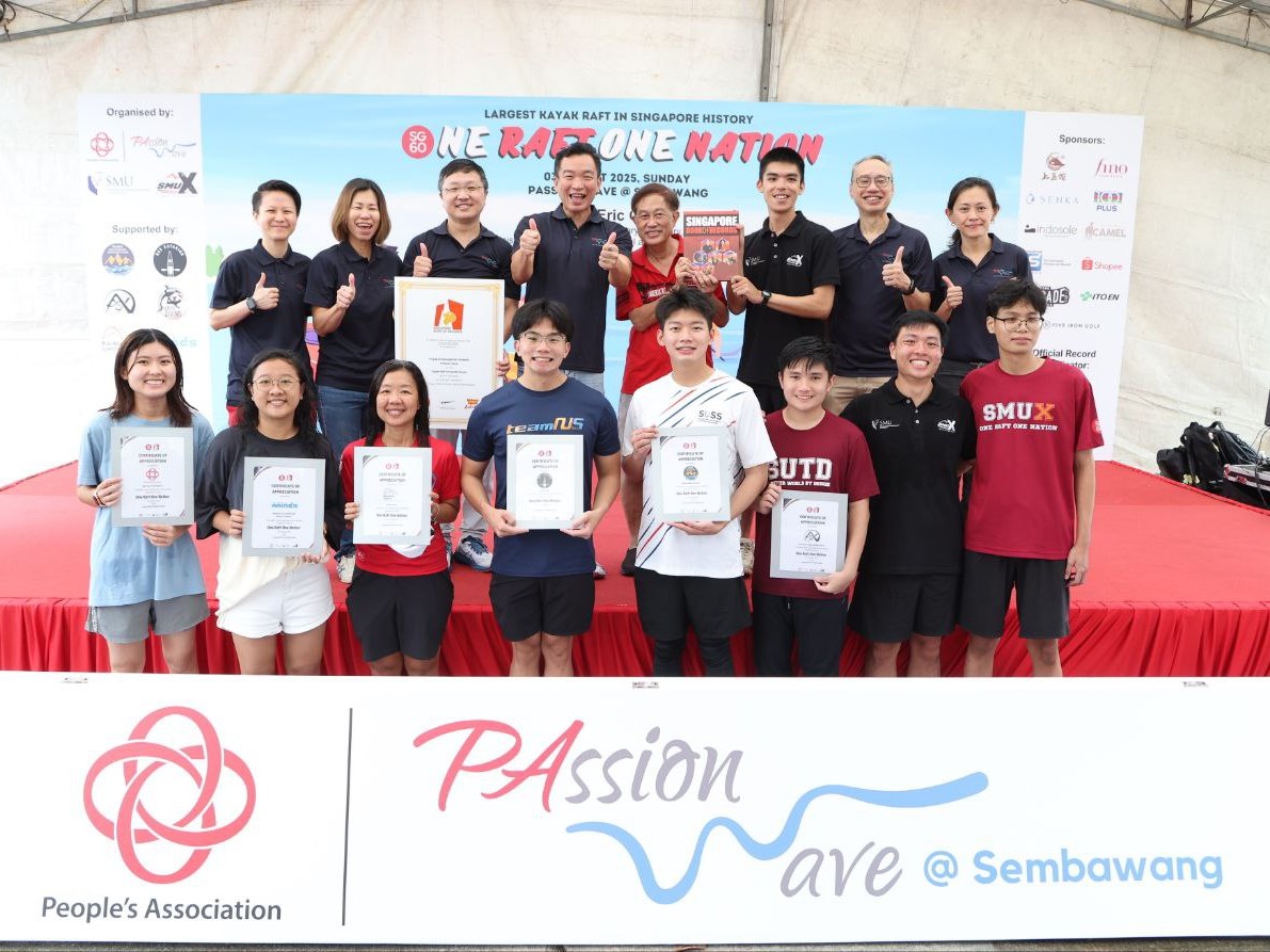 Representatives from each participating university and PAssionWave stand proudly together, holding the record-breaking certificates for forming Singapore’s largest kayak raft formation.