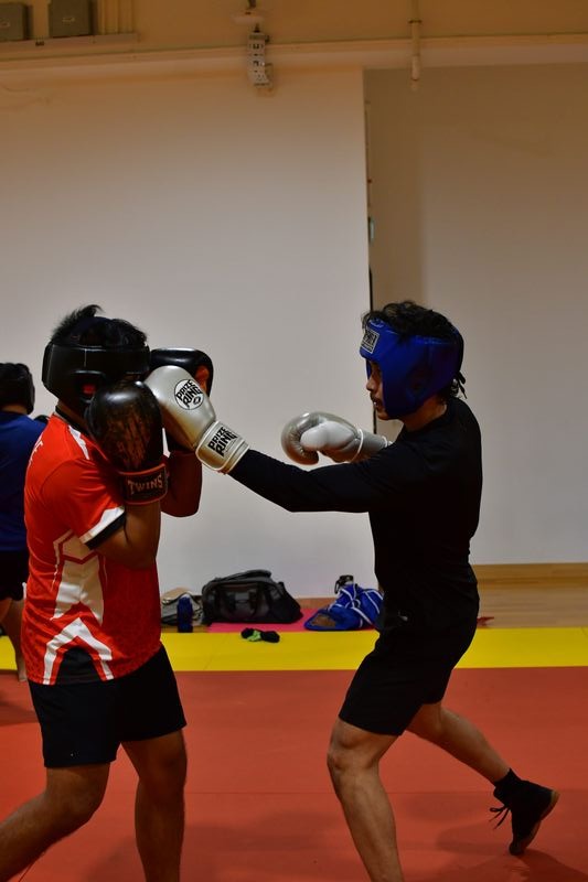 05-Jan-body-article_SUSS Boxing member Aniq throwing a jab toward_GINA ZHI XUAN LIM SUSS Boxing member Aniq throwing a jab toward