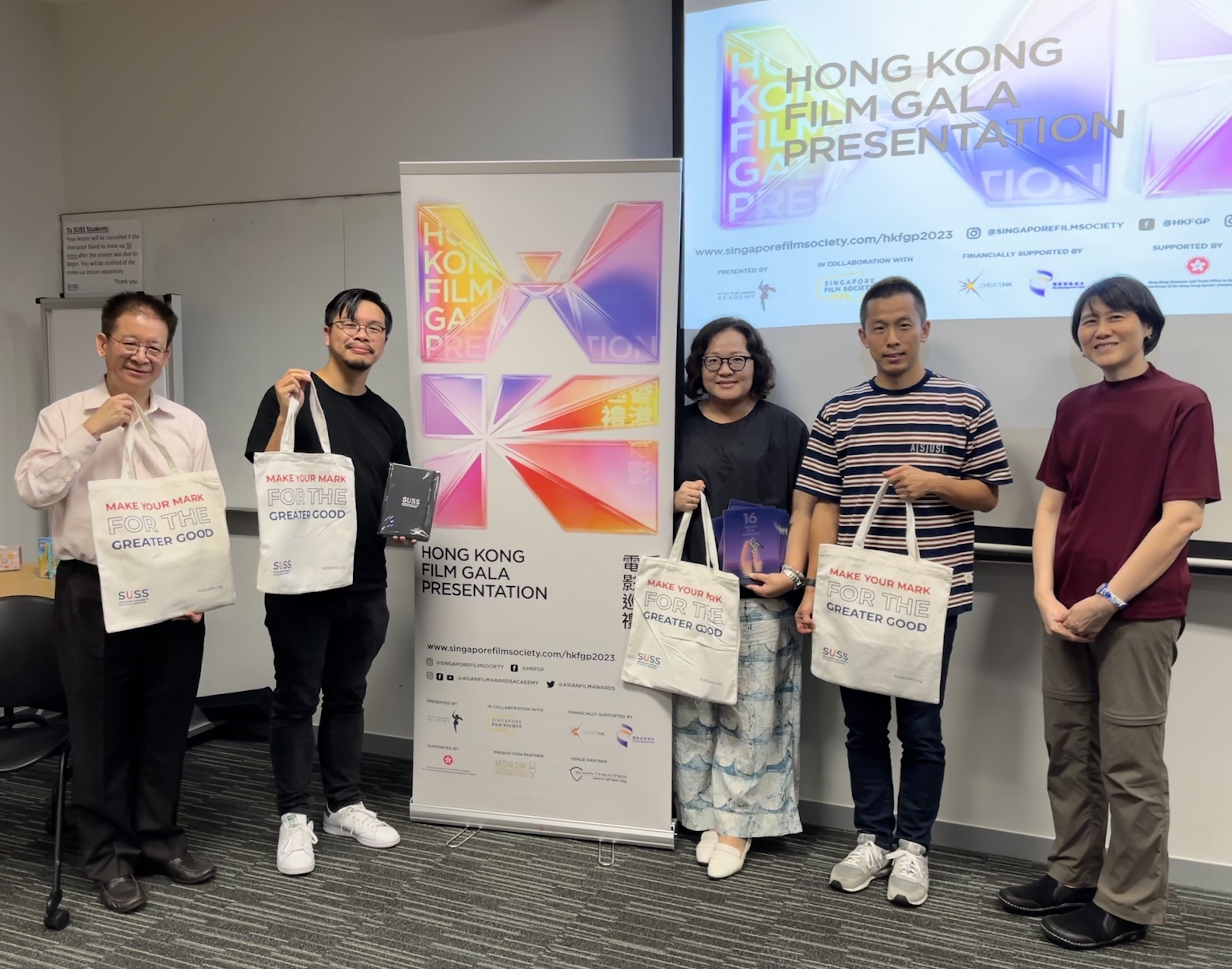 6_guests pose w bags 6_guests pose w bags