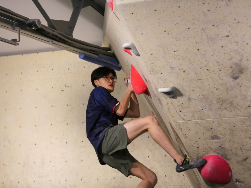 Lou Yan Xiang, Enzo eyeing the next hold on the wall.