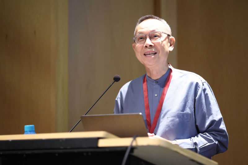Person speaking at a podium with a microphone