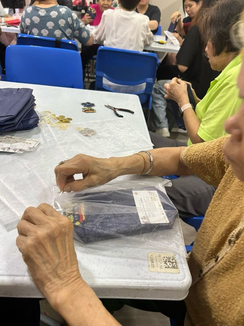 Seniors from Lion Befrienders’ Active Ageing Centre (Ghim Moh) assembling table gifts with care and creativity