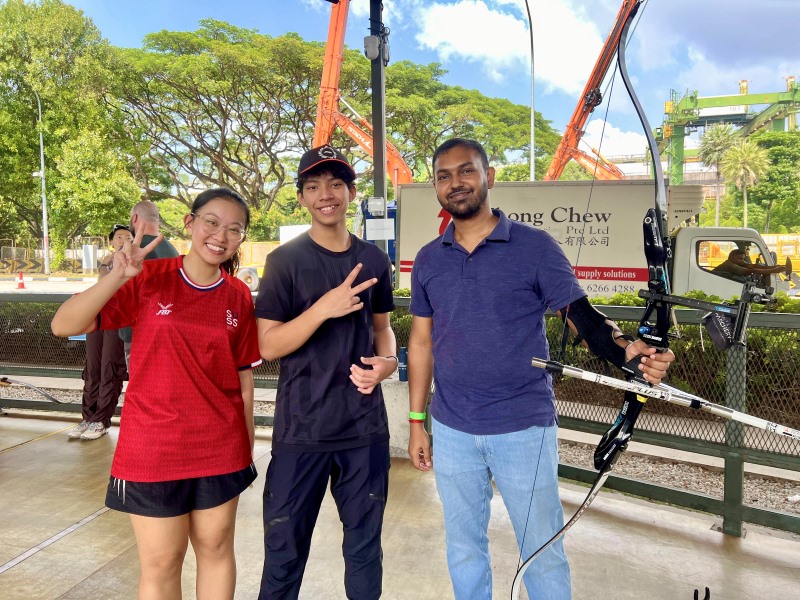 Smiles as a SUSS Archery team member commemorates the day with BMDP donors and volunteers