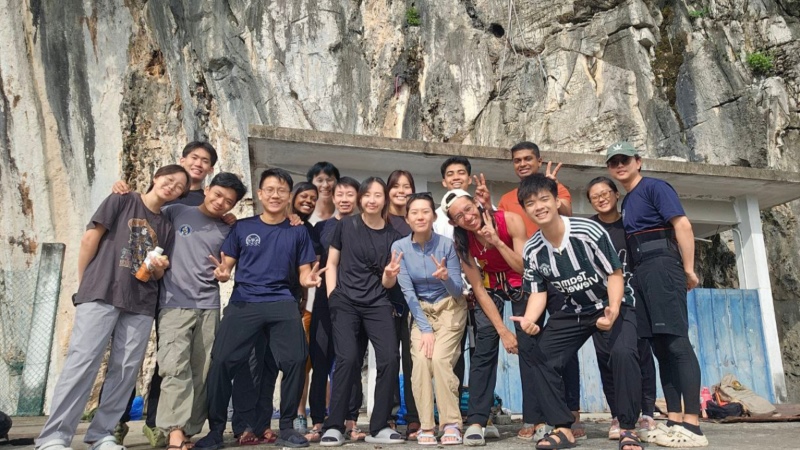 Students pose together with smiles and anticipation on the second day of outdoor climbing – ready to conquer Gua Lepak as a team.