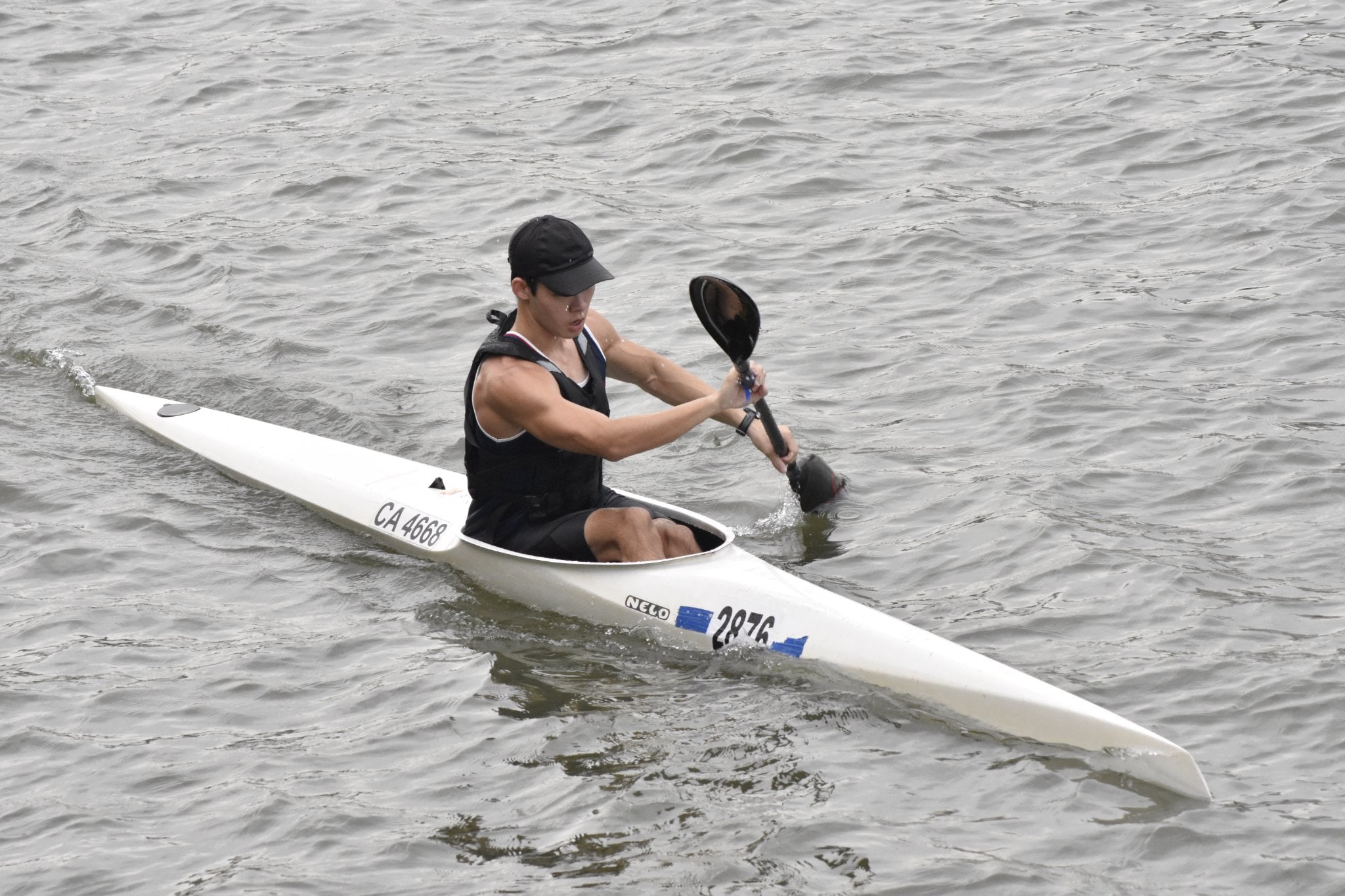 SUSS Canoeing Senior Men’s K1 athlete navigating challenging race conditions during the event. SUSS Canoeing Senior Men’s K1 athlete navigating challenging race conditions during the event.