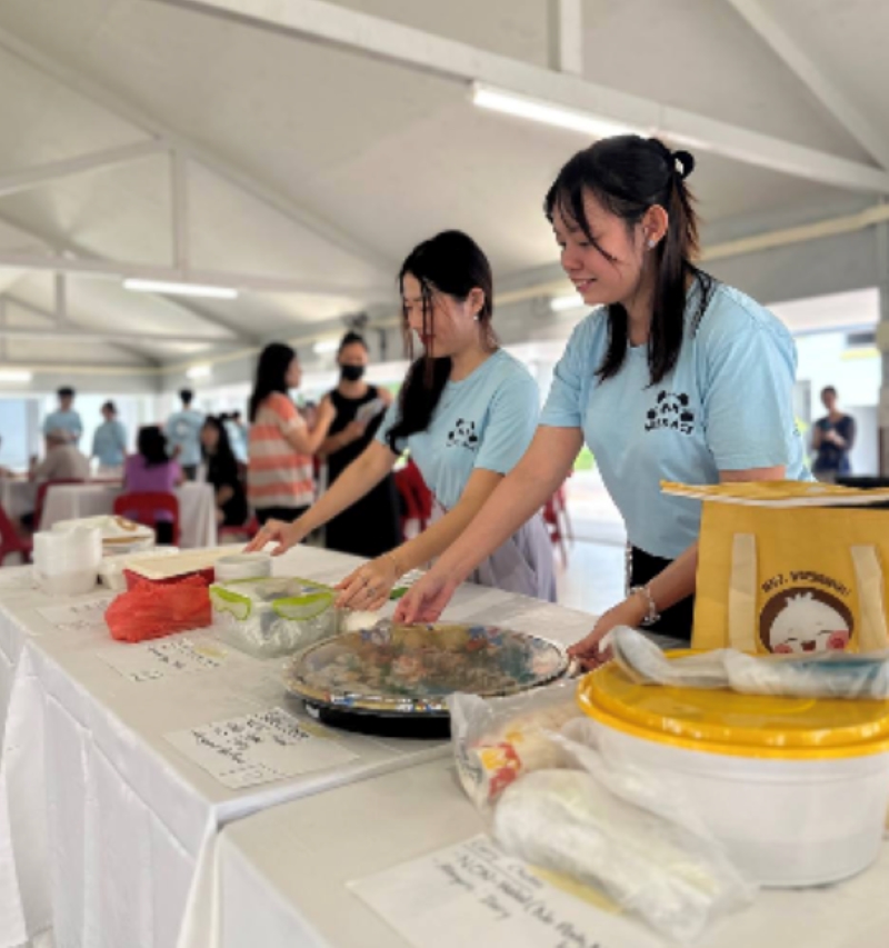 Two of the ACE Student Leaders are preparing for the potluck competition for the residents there.