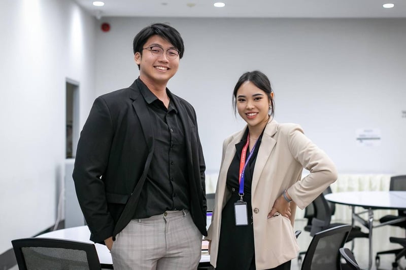 Two people smiling in an office setting