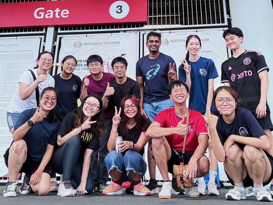 Volunteers gather for a group photo after a fulfilling Day 1 filled with board games and bonding activities.