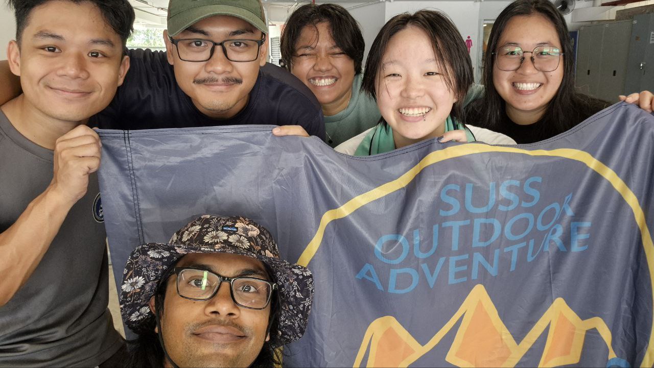Marking the final kayaking session with MINDS, the volunteers pose proudly with the ODAIG flag as they celebrate a meaningful journey filled with shared experiences, growth, and connection on the water.