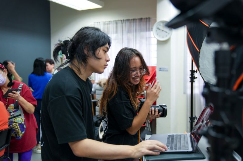 Zack (left) and Zeti (right) reviewing the photos after a couple of shoots for the beneficiaries