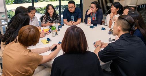 Participants engaging in deep sharing and discussions at each table.