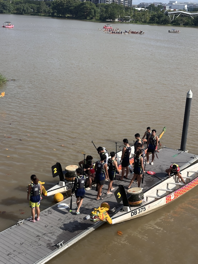 SUSS Dragon Boat Team boarding the boat at the pontoon in preparation for the race.JPG
