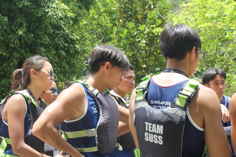 SUSS Dragon Boat Team gathered for a pre-race briefing ahead of the SDBA Century Race 2026
