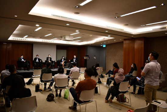SUSS School of Law student, Muhammad Matin Bin Abdul Razak (standing), posing a question to the panellists.
