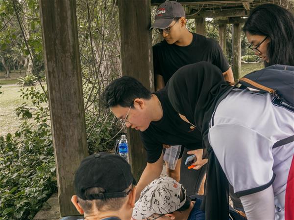 SUSS students working together with CCF youths to solve riddles during the amazing race challenge!
