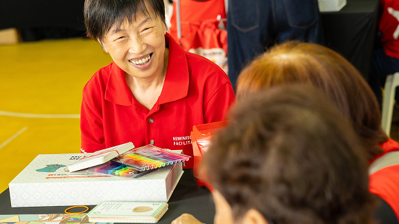 A reminiscence facilitator engaging older adults during a session