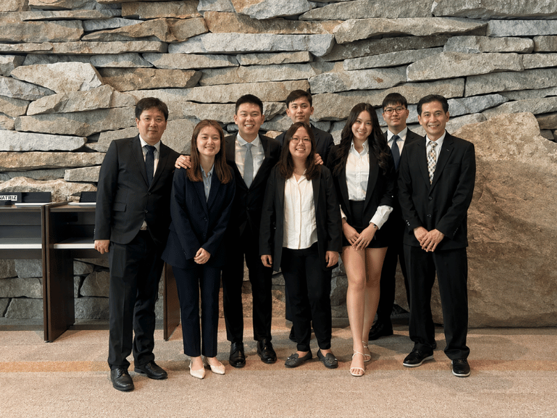 Group of people in suits posing for a photo
