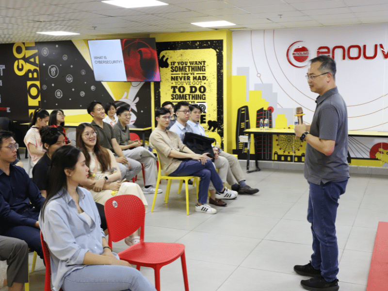 Group of people sitting and listening to a man speak
