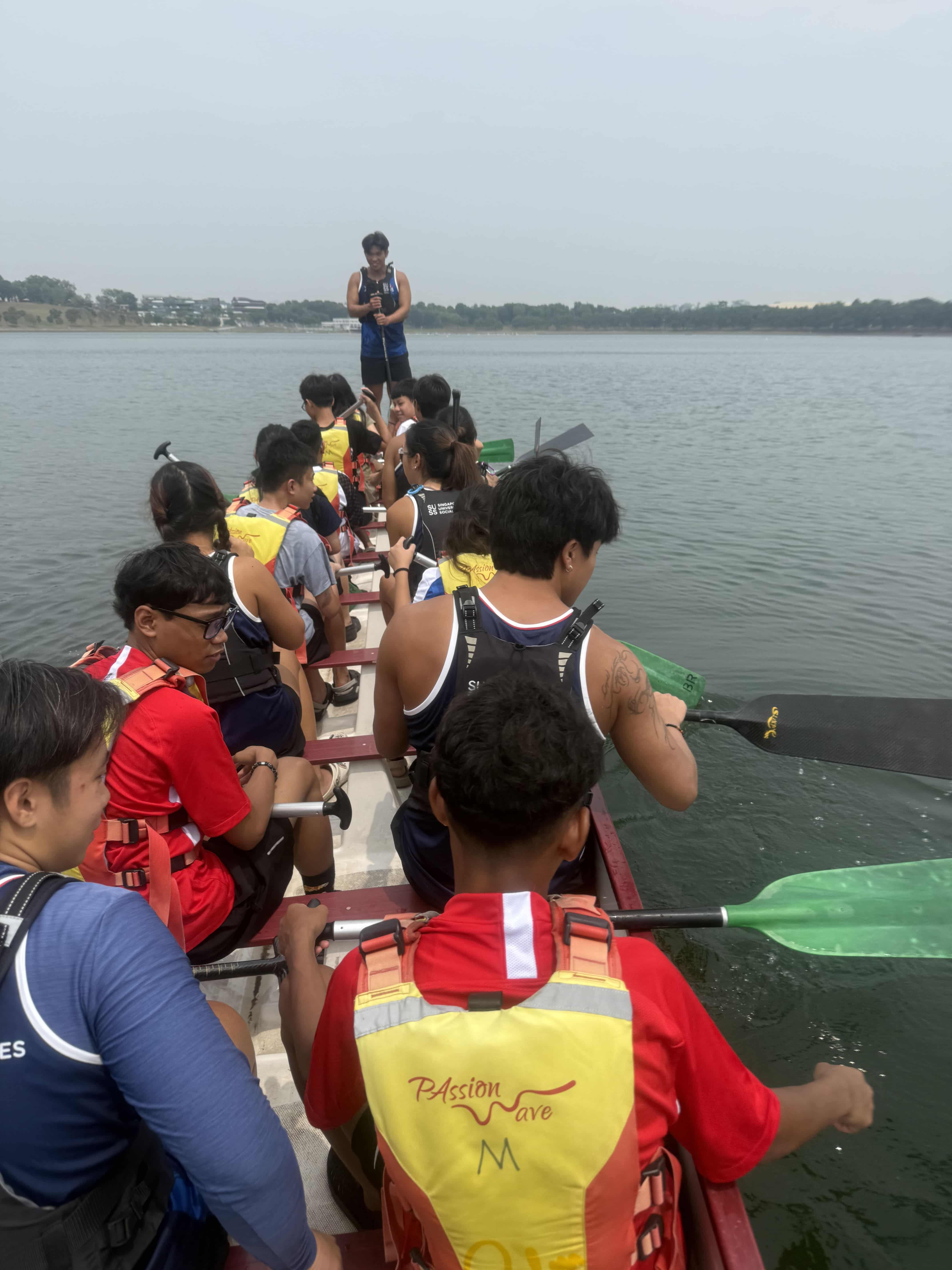 Participants practicing basic paddling with DB members