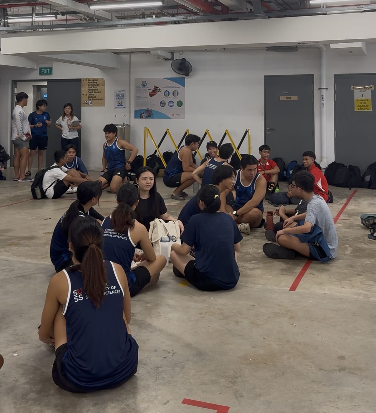 Participants sitting in groups with SUSS Dragon Boat CG