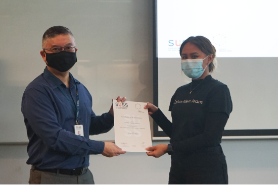 Professor Robbie Goh, SUSS Provost (left), presents the Certificate of Achievement to Marielyn Kamarudzaman, SUSS Marketing Student (right), who placed second overall.
